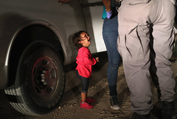 Honduran cries as her mother is searched and detained