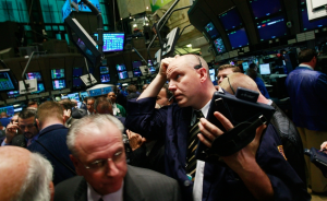Traders work on the floor moments before the morning bell at the New York Stock Exchange, November 21, 2008
